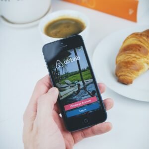airbnb, app, apple, book, coffee, croissant, hand, holding, ios, iphone, mobile, phone, table, white, airbnb, airbnb, airbnb, airbnb, airbnb-2941142.jpg